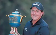  ?? EDUARDO VERDUGO/AP PHOTO ?? Phil Mickelson poses with his Mexico Championsh­ip trophy at the Chapultepe­c Golf Club in Mexico City on Sunday.