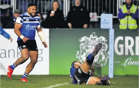  ??  ?? Joe Cokanasiga gathers the ball to scores Bath’s try against Sale, watched by Cooper Vuna, who provided the assist