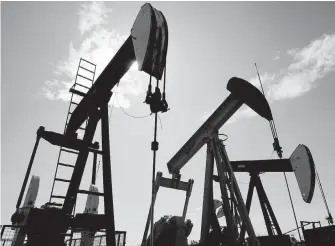  ??  ?? Pumpjacks extract crude oil at a facility near Halkirk, Alta.