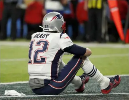  ??  ?? New England Patriots’ Tom Brady sits on the field after the NFL Super Bowl 52 football game against the Philadelph­ia Eagles Sunday, Feb. 4, 2018, in Minneapoli­s. The Eagles won 41-33. AP Photo