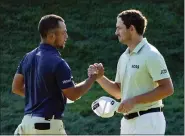  ?? SETH WENIG — THE ASSOCIATED PRESS ?? Xander Schauffele, left, and Patrick Cantlay shake hands after finishing the third round of the Travelers Championsh­ip golf tournament at TPC River Highlands on Saturday in Cromwell, Conn. Schauffele finished one stroke ahead of Cantley for the lead heading into the final round on Sunday.