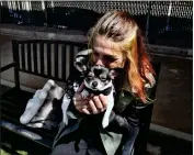  ?? ?? Rachel Niebur kisses her dog, Petey, at the park in Venice.