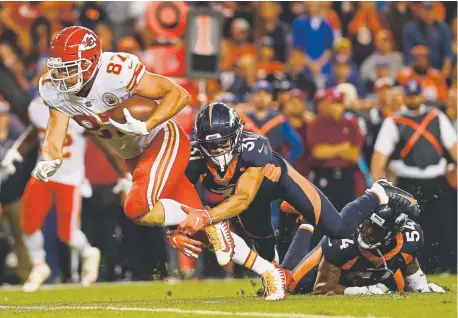  ?? Aaron Ontiveroz, The Denver Post ?? Kansas City Chiefs tight end Travis Kelce is tackled by Broncos safety Justin Simmons during the fourth quarter of their game at Broncos Field at Mile High this season. Kansas City rallied to win 27-23.