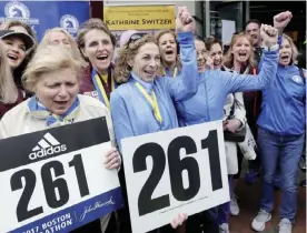  ??  ?? BOSTON: Kathrine Switzer, middle with fist up, the first official woman entrant in the Boston Marathon 50 years ago, cheers at a news conference, Tuesday, in Boston, where her bib No. 261 was retired in her honor by the Boston Athletic Associatio­n....