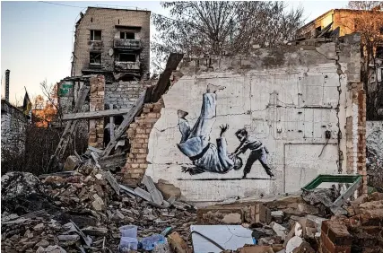  ?? PICS: ED RAM ?? Banksy-style street art on a wrecked building in Borodyanka