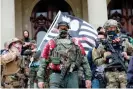  ?? Photograph: Jeff Kowalsky/AFP/Getty Images ?? A group tied to the Boogaloo Bois holds a rally at the Michigan state capitol in Lansing, on 17 October 2020.