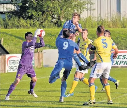  ?? Michael Vaughan-Muscat (centre) in action against Warrington Town in Skelmersda­le United’s 2-2 friendly draw on Tuesday Picture by John Driscoll ??