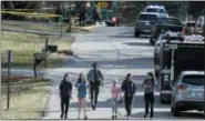  ?? JOHN MINCHILLO — THE ASSOCIATED PRESS ?? Residents of as escorted from the site of a plan crash on Rollymeade Ave, Tuesday in Madeira, Ohio. Authoritie­s say a small plane has crashed into a house in a suburban Cincinnati community, killing the pilot.