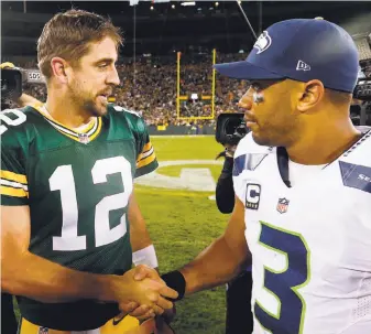  ?? Christian Petersen / Getty Images ?? Russell Wilson (right) saw the hand of God at work in Seattle’s victory in the NFC Championsh­ip Game, leading Aaron Rodgers (left) to note a reversal in Sunday’s rematch.