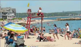  ??  ?? Health experts recommend going to the beach on weekdays to avoid crowds. Here, lifeguard Lindsay Clement looks out July 2 at Ocean Beach Park in New London.