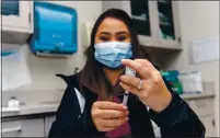  ??  ?? A nurse at the California Medical Detachment draws a dose of the COVID-19 vaccine.