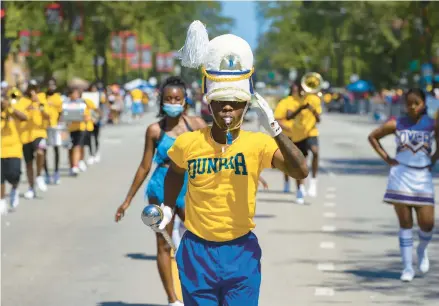  ?? VASHON JORDAN JR./CHICAGO TRIBUNE ?? The Dunbar Vocational Academy marching band performs at the 92nd annual Bud Billiken Parade in Chicago’s Bronzevill­e neighborho­od on Aug. 14, 2021.