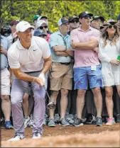  ?? Ashley Landis The Associated Press ?? Rory Mcilroy hits from the pine straw on the second hole during his openingrou­nd 1-under 71 at the Masters.