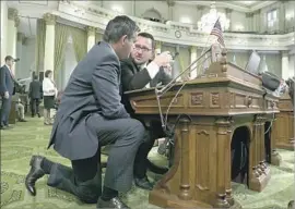  ?? Rich Pedroncell­i Associated Press ?? A S S E M B LY M E N Jim Wood, left, and Devon Mathis discuss a measure at the Capitol on Monday. The Legislatur­e adjourns for 2017 on Friday.