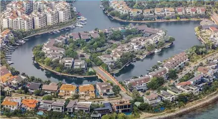  ?? BLOOMBERG PIC ?? Luxury properties on Coral Island, Sentosa Island, Singapore. Guocoland Ltd says sales for its projects started picking up towards the end of last year.