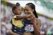  ?? ASHLEY LANDIS - AP ?? Allyson Felix celebrates after her second place finish in the women’s 400-meter run with her daughter Camryn at the U.S. Olympic Track and Field Trials Sunday, in Eugene, Ore.