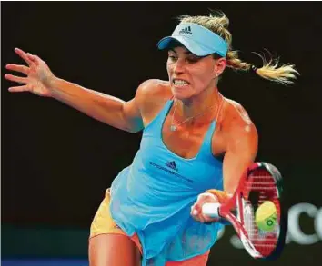  ?? Reuters ?? Angelique Kerber hits forehand during her women’s singles first round match against Ukraine’s Lesia Tsurenko in Melbourne yesterday. The German advanced with a three-set win.