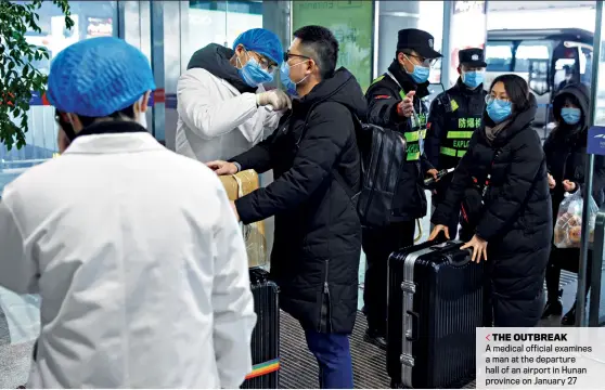  ?? THOMAS PETER/ REUTERS ?? THE OUTBREAK
A medical official examines a man at the departure hall of an airport in Hunan province on January 27