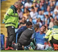  ?? Photo: AFP. ?? Aymeric Laporte receives medical attention.