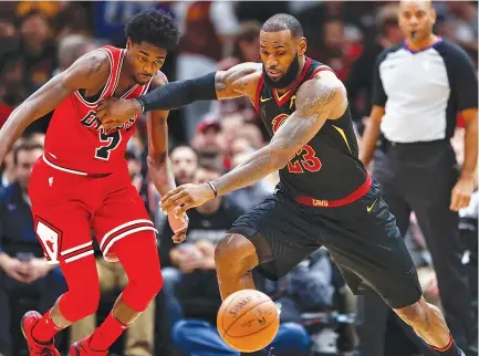  ??  ?? CLEVELAND CAVALIERS forward LeBron James battles for the ball against Chicago Bulls guard Justin Holiday during the first half at United Center.