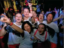  ??  ?? Teens have fun dancing under black lights and strobe lights during SouderTHON at Souderton Area High School.