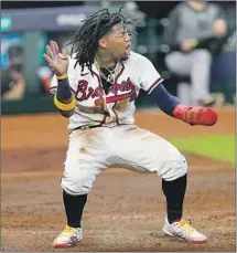  ?? Eric Gay Associated Press ?? THE BRAVES’ Ronald Acuna Jr., who homered leading off the bottom of the f irst, reacts after scoring during the third inning.