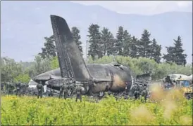  ?? AFP ?? Rescue workers around the wreckage of the Algerian army plane which crashed.
