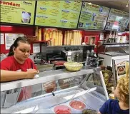  ?? KARA DRISCOLL/STAFF ?? Emily Dyer of Springfiel­d takes a customer order at Young’s Jersey Dairy.