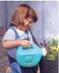  ?? JAN RIGGENBACH ?? Even very young children enjoy garden activities such as poking seeds into the soil or watering plants