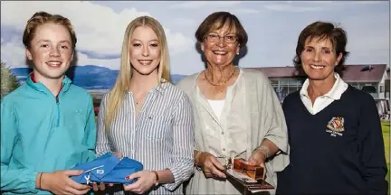  ??  ?? Category 1 winners Oisin Conroy and Nora Byrne receive their prize from, Amy Rafferty (Declan Rafferty Catering) and Lady Captain Jean Connolly after winning the Adult and Child Scotch Foursomes at Dundalk.