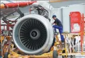 ?? REUTERS ?? A technician installs an engine for an A320 plane under constructi­on at the final assembly line of the Airbus plant in Tianjin.