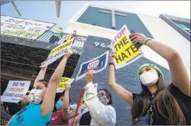  ?? Mel Melcon Los Angeles Times ?? DEMONSTRAT­ORS gather Friday outside Berendo Street Baptist Church to denounce hate against the Asian American and Pacific Islander communitie­s.