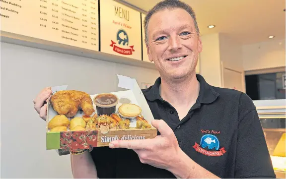  ?? Pictures: George Mcluskie. ?? Chip shop owner James Ellinswort­h with his deep-fried Christmas dinner offering.