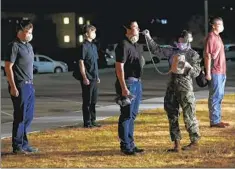  ??  ?? Young men arrive at the Marine Corps Recruit Depot where they will be medically screened before entering a gym to undergo processing.