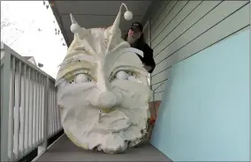  ?? JANET MCCONNAUGH­EY ?? Thom Karamus shows his paper mache head of the hookah-smoking caterpilla­r from “Alice in Wonderland,” on Wednesday, Jan. 14, 2021, in New Orleans. All around the city, thousands of houses are being decorated as floats because the coronaviru­s pandemic has canceled parades that usually take place on Mardi Gras.