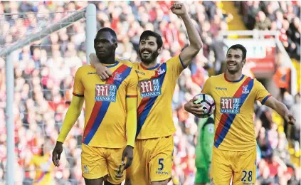  ?? Picture: Reuters ?? TAKE THAT. Crystal Palace’s Christian Benteke, left, celebrates his first of two goals scored with team-mates during their Premier League encounter against Liverpool at Anfield yesterday.