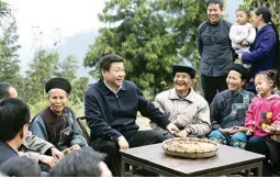  ??  ?? Chinese President Xi Jinping, center, talks with local villagers and cadres at Shibadong village in Paibi Township of Huayuan County in the Tujia-Miao Autonomous Prefecture of Xiangxi in central China’s Hunan Province. (Xinhua via AP)