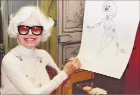  ?? Photos from Associated Press ?? Carol Channing, star of the original “Hello, Dolly,” left, poses in costume in 1978. At right, Channing signs a lithograph of herself by caricaturi­st Al Hirschfeld at her home in Beverly Hills, Calif. Channing died Tuesday at 97.