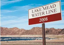  ?? MARIO TAMA GETTY IMAGES ?? A water line marker from the year 2008 is posted along droughtstr­icken Lake Mead on Monday in the Lake Mead National Recreation Area in Nevada.