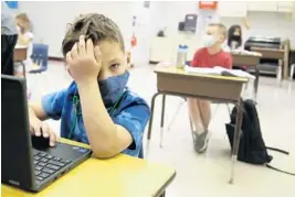  ?? MIKE STOCKER/SOUTH FLORIDA SUN SENTINEL ?? Jackson Ross attends first grade during the first day of face-to-face classes at Plantation Park Elementary School in Plantation on Oct. 9.