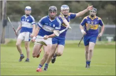  ??  ?? Barndarrig’s Malachy Stone sets up an attack while under pressure from Carnew’s Paul Murphy.