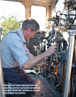  ??  ?? Fireman Paul Lewin demonstrat­es the easiest way to fire Lyd as the locomotive pauses at Minffordd, waiting for access to the single-line section.