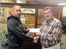  ?? COURTESY PHOTO ?? Larry Vancuren, president of Cornerston­e Bank, presents Fire Chief Shane Clark (left) with a donation in the amount of $10,000. The funds will be used towards the purchase of a new fire engine for Southwest City.