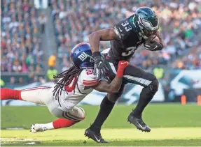  ?? BILL STREICHER/USA TODAY SPORTS ?? Eagles running back Josh Adams, who finished with 84 yards and one TD, breaks Giants cornerback Janoris Jenkins’ tackle attempt.