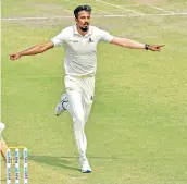  ??  ?? Bengal’s Ishan Porel celebrates a Karnataka wicket in Kolkata on Sunday.