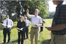  ?? Carol Kaliff / Hearst Connecticu­t Media file photo ?? Joel Lindsay, with Ameresco Candlewood Solar, leads a walking tour for the state Siting Council last summer. The panel was examining the area for a proposed solar panel on Candlewood Mountain in New Milford.