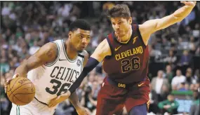  ?? Charles Krupa / Associated Press ?? Marcus Smart, left, drives against Cleveland’s Kyle Korver during the second half on Tuesday.