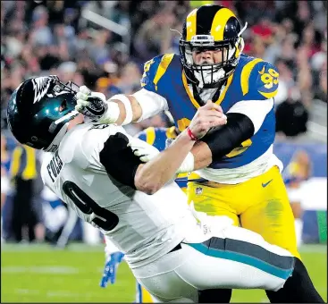  ?? — AP FILES ?? Los Angeles Rams defensive end Aaron Donald sacks Eagles quarterbac­k Nick Foles in a game earlier this season. Donald will have to be at his disruptive best today.