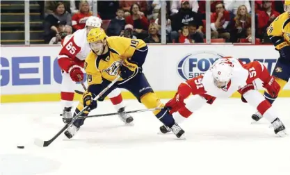  ??  ?? DETROIT: Detroit Red Wings center Frans Nielsen (51) defends Nashville Predators center Calle Jarnkrok (19) during the first period of an NHL hockey game yesterday in Detroit.—AP