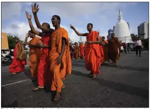  ?? (AP/Eranga Jayawarden­a) ?? Student Buddhist monks in Colombo, Sri Lanka, shout slogans as they march Monday demanding President Gotabaya Rajapaksa resign over the economic crisis. Sri Lankans are facing a severe economic crisis that has ravaged household budgets amid high inflation.